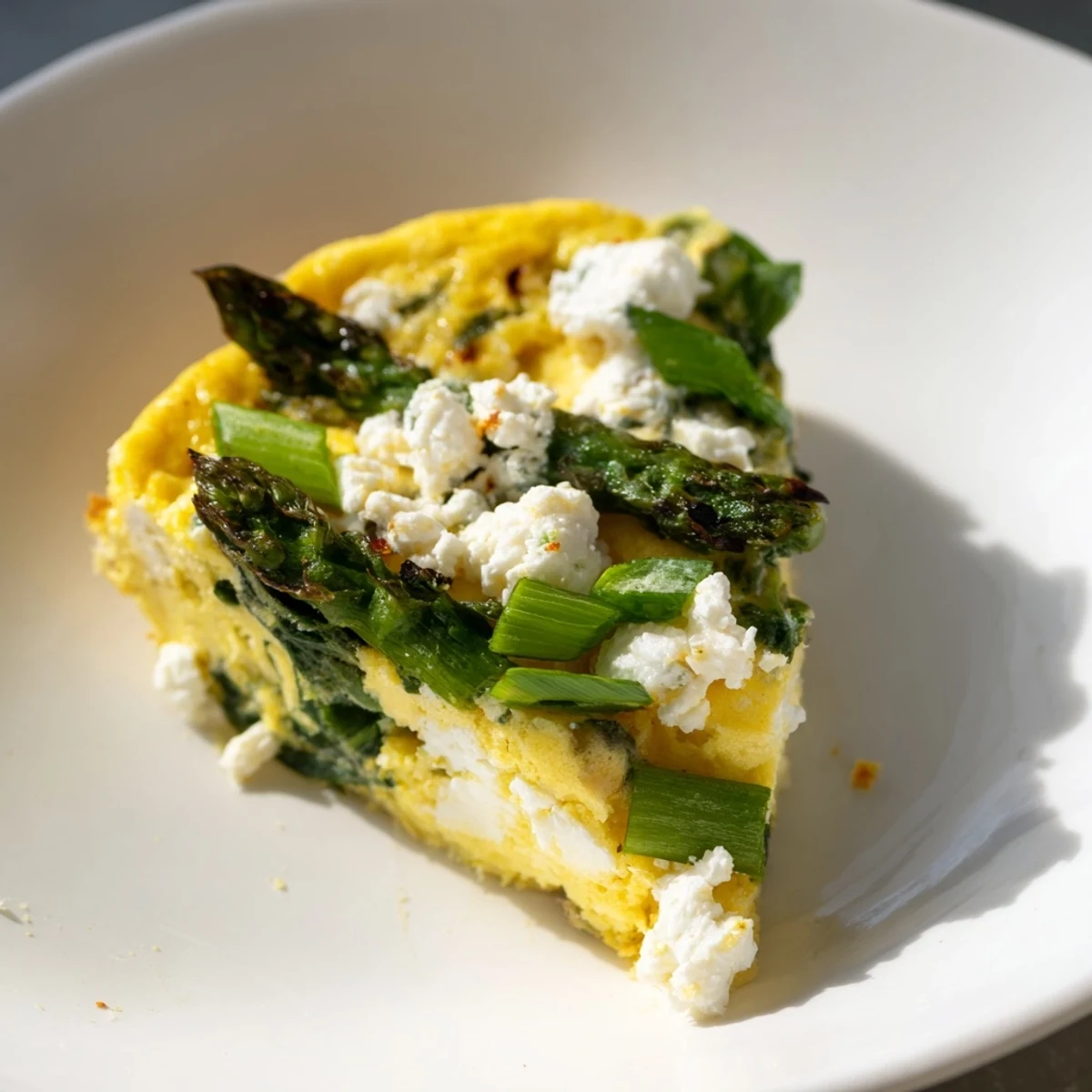 Golden crust of Meadow-Soft Cozy Plate: Frittata with Spring Greens, rich with goat cheese.