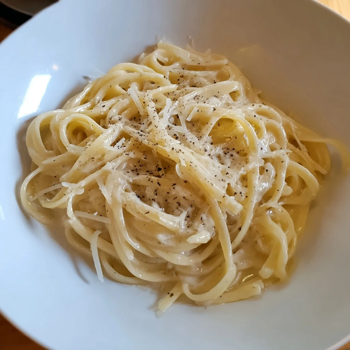 Creamy Lazy Girl Three-Ingredient Pasta; buttery strands coated with Parmesan, ready to savor.