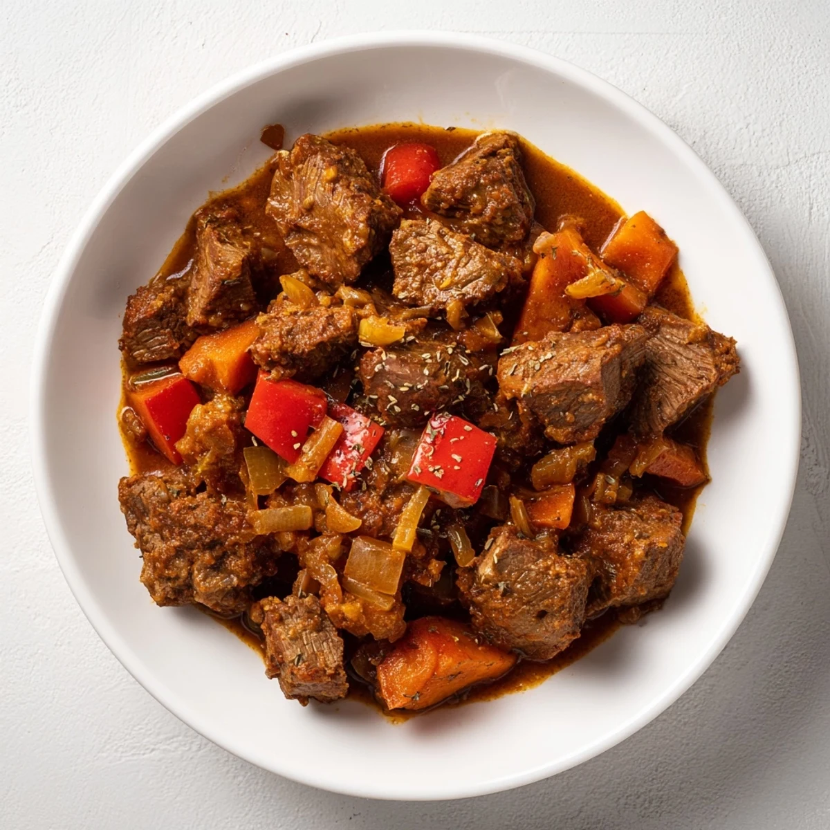 Steaming bowl of Hungarian Goulash Stew with tender beef, peppers, and rich, savory broth, ready to serve.