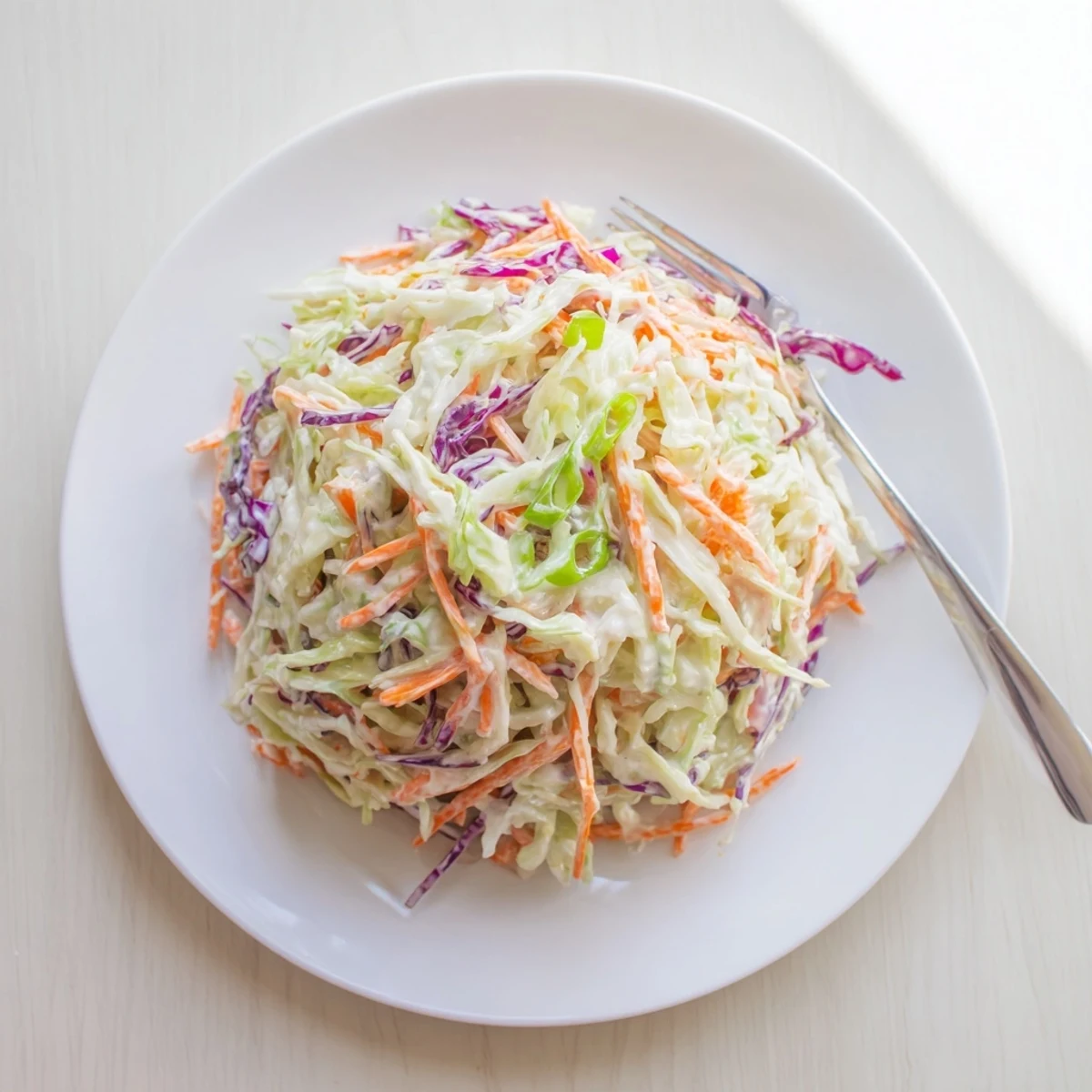 Chilled Best Cabbage Coleslaw served in a bowl, perfect for summer picnics and barbecues.