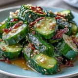 A vibrant smashed cucumber salad with chili garlic oil, combining crisp vegetables and a tangy, aromatic dressing.
