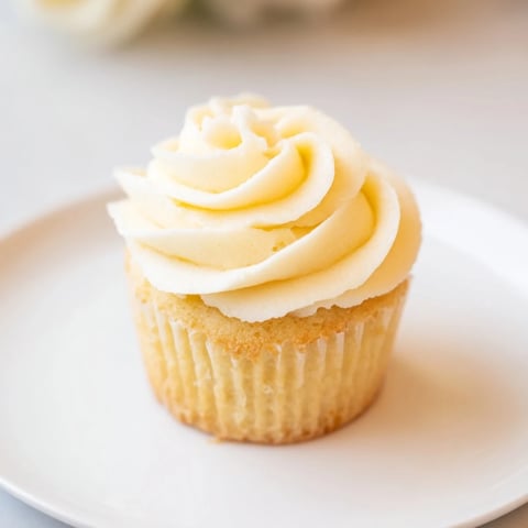 Fluffy vanilla cupcakes with buttercream frosting, a classic dessert perfect for any occasion.