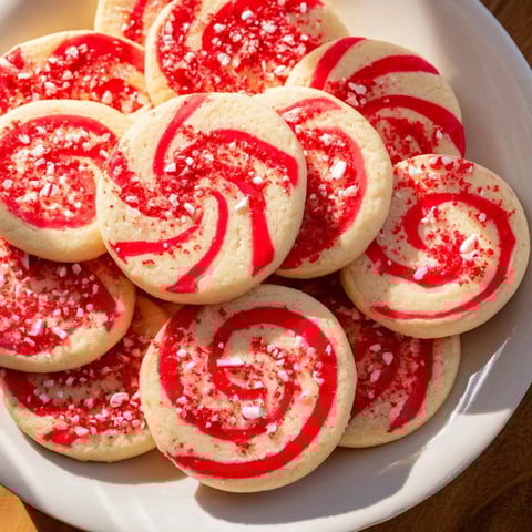 Close-up of Candy Cane Swirl Cookie Platter, showcasing vibrant red and white peppermint swirls.