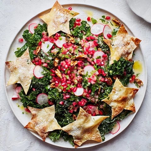 Festive Winter Salad with crunchy, snowflake-shaped tortilla chips, vibrant salsa, and fresh winter greens.