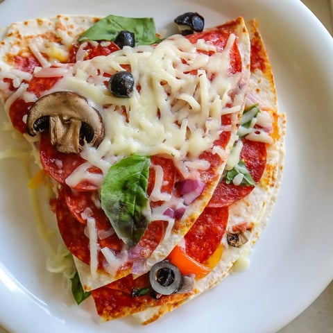 Golden and crispy tortilla pizza wrap, filled with melted cheese and savory pepperoni right from the pan!