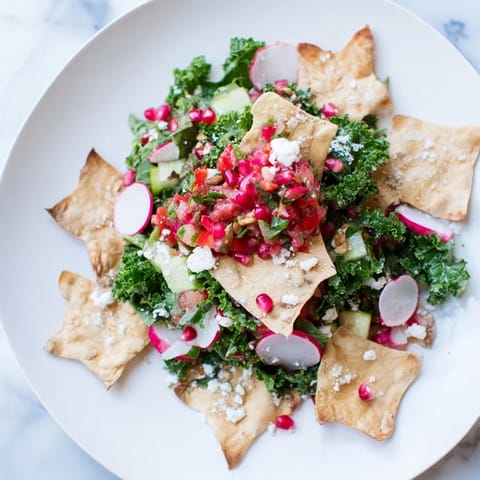 Bright red tomatoes and crunchy tortilla snowflakes top this Winter Salad, bursting with fresh flavors.