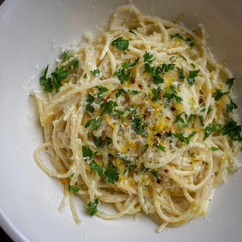 This bright Lemon-Garlic Greek Yogurt Pasta shows perfectly twirled spaghetti, tossed in a creamy sauce.