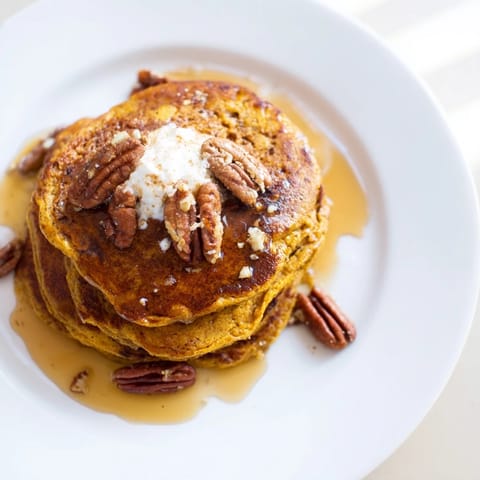 Warm and spiced fluffy pumpkin spice pancakes, cooked perfectly for a delicious breakfast treat.