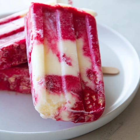 These homemade Raspberry Coconut Ice Pops, bursting with color, offer a cool, refreshing summer treat for everyone.