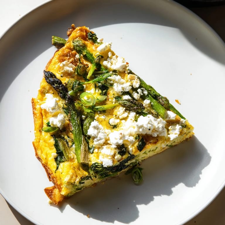 A hearty slice of Meadow-Soft Cozy Plate: Frittata showcases the creamy goat cheese and fresh veggie mix.