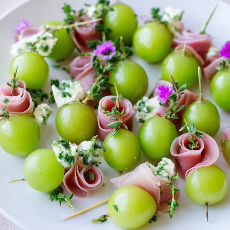 A close-up of the elegant Mistletoe Kissing Ball, ready-to-serve with fresh herbs and cheese bites.