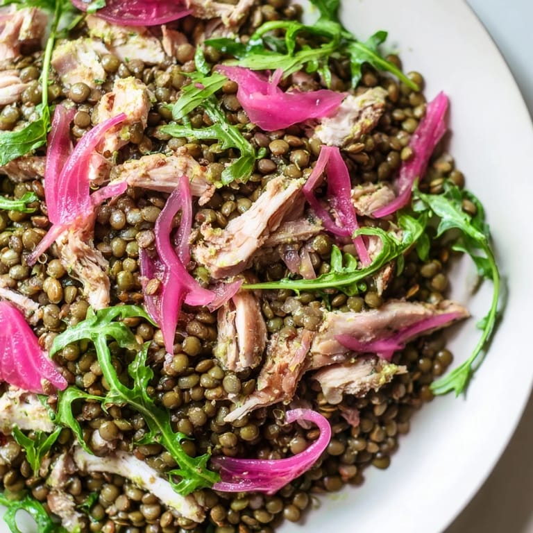 Healthy Lentil & Chicken Spring Salad close-up, highlighting the texture of lentils, arugula, and shredded chicken drizzled with homemade mustard vinaigrette.