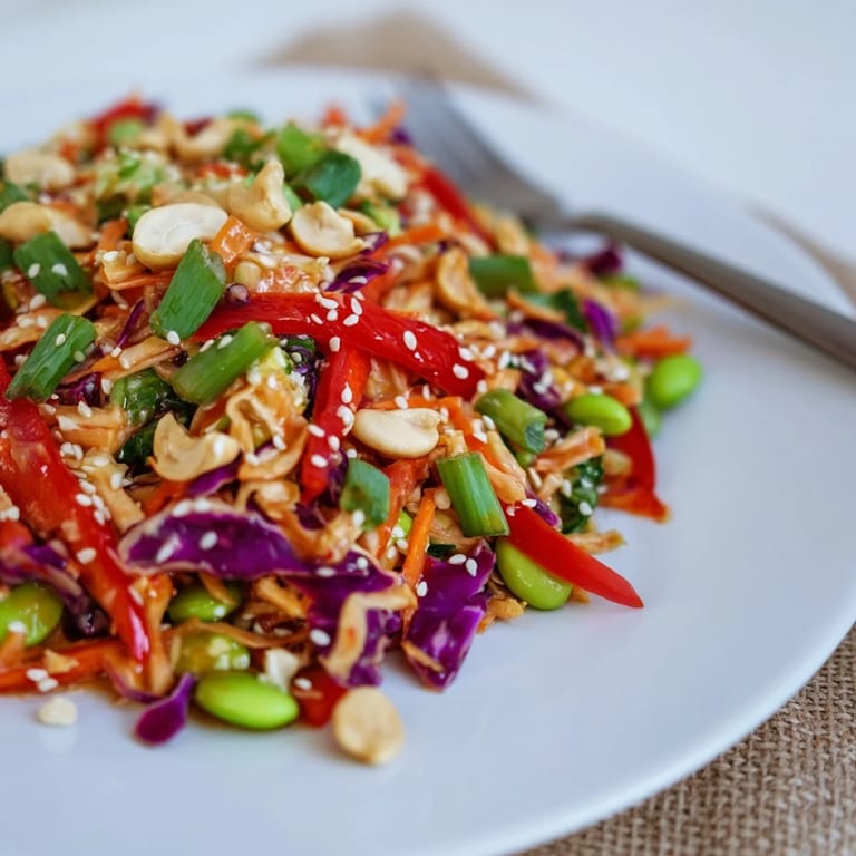 Edamame Crunch Chicken Salad tossed with green and red cabbage, edamame, and red bell pepper, dressed in a homemade ginger soy vinaigrette.