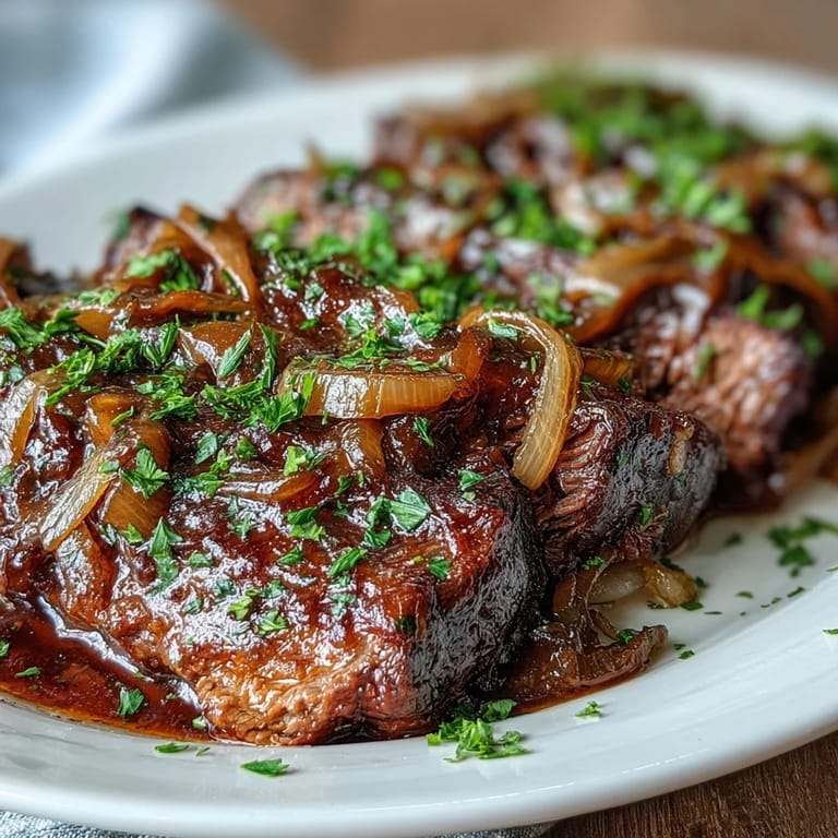Savory Crock Pot French Onion Pot Roast topped with fresh parsley, featuring fall-apart beef slices drenched in a hearty red wine sauce.