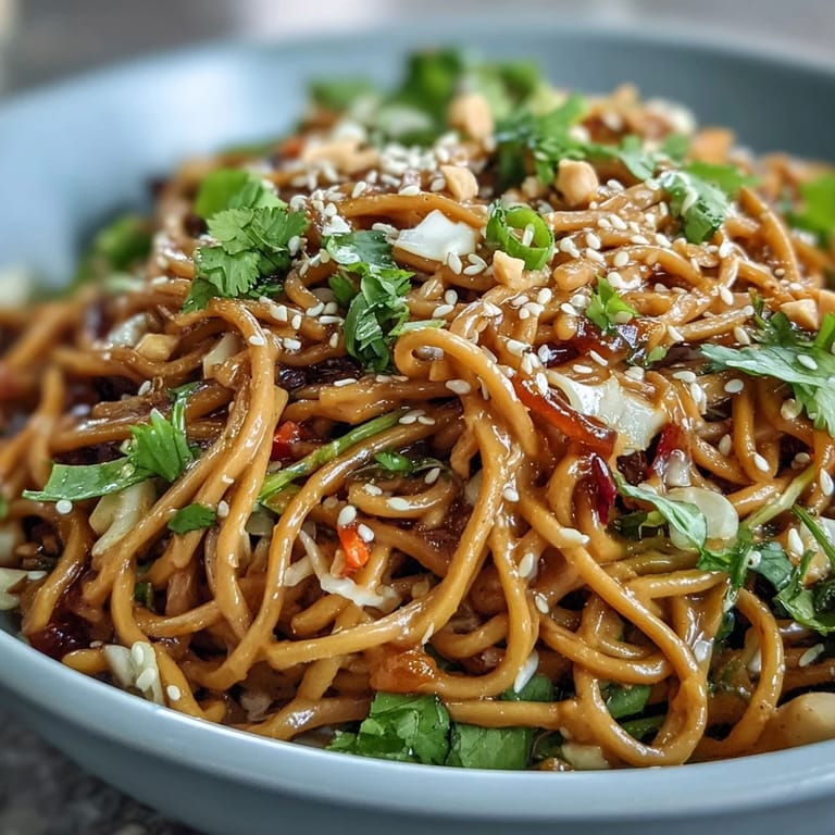 Vegan Spicy Peanut Soba Noodle Salad with Crunchy Slaw: Fresh soba noodles tossed in a creamy spicy peanut sauce with vibrant red and green cabbage, carrots, and bell peppers for a crunchy texture.